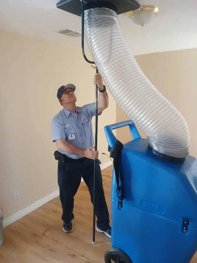 Furnace Tune-Up technician using HEPA equipment in Spanaway